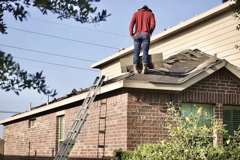 Professional roofer working on a residential roof in Fairmount Park